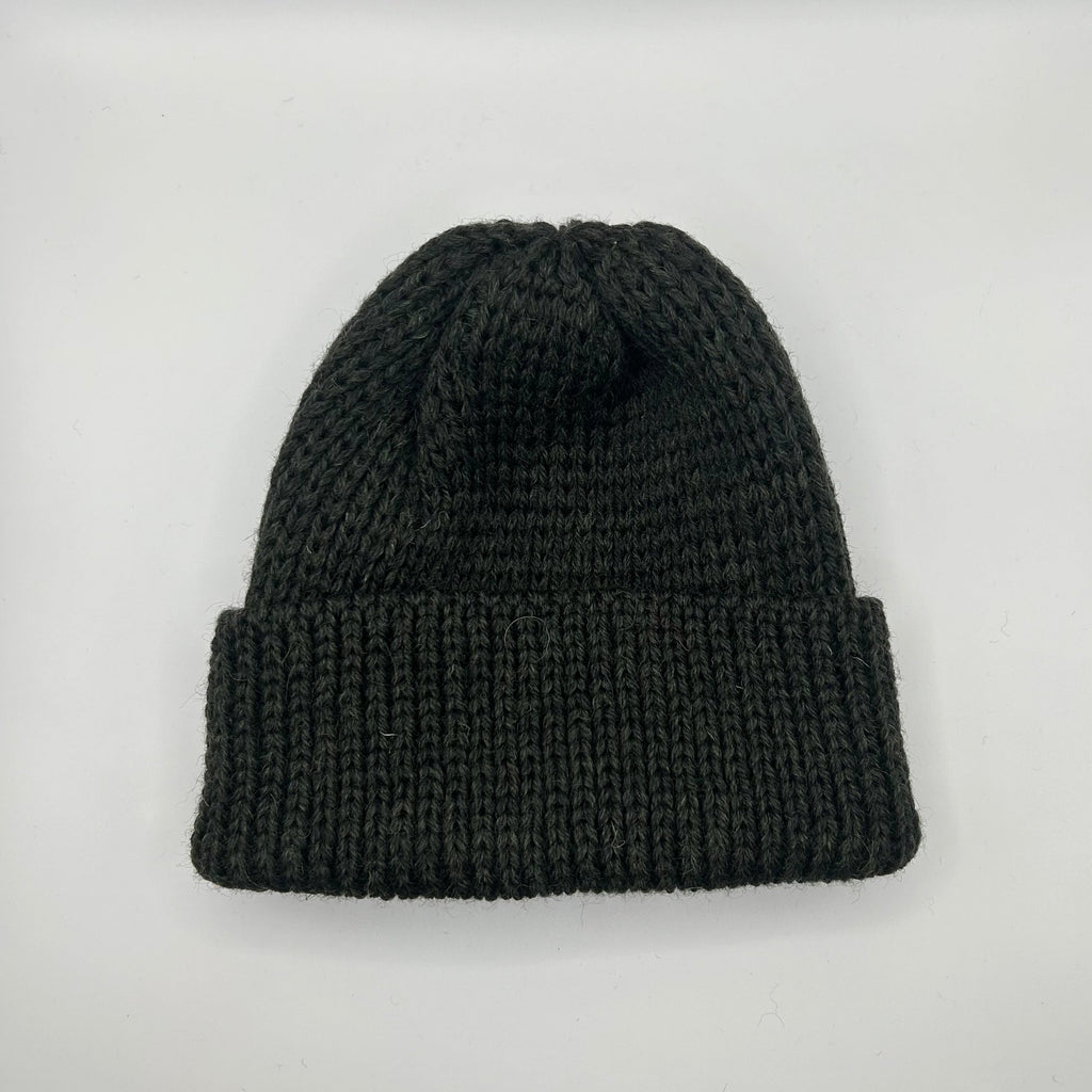 A black pure wool beanie with a chunky knit pattern