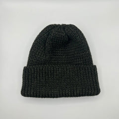 A black pure wool beanie with a chunky knit pattern